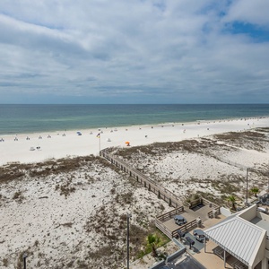 This bright living area features a large window showcasing a stunning beachfront view, perfect for relaxation and enjoyment
