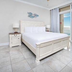 Retreat to the king master suite with cozy bedding and drift off to the sound of the waves from the balcony