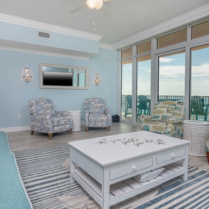 Relax on the cozy sofa in this inviting family room with breathtaking beachfront views