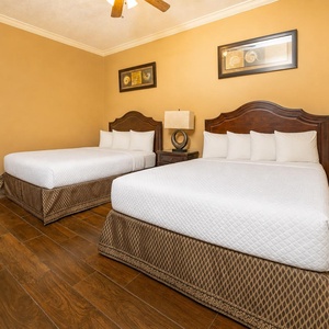 Two queen beds cradle you in plush comfort in this guest suite after a day of family adventures near the coast