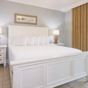 Retreat to the king master suite with cozy bedding and drift off to coastal sights and sounds of the bay