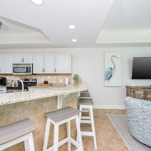 Gather around the stylish bar area with comfortable seating, perfect for enjoying meals and conversations