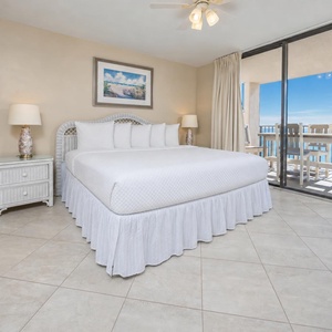 Unwind in the spacious master bedroom with a king bed and beachfront balcony access