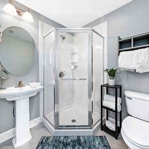 Step into the glass shower to rinse under the wall showerhead and enjoy fresh soft towels