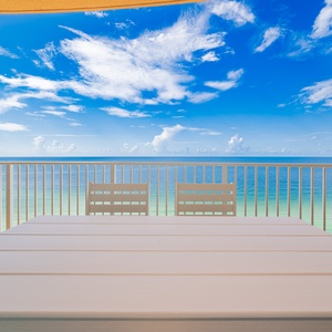 Dine at the outdoor table while enjoying expansive views of the tranquil waters and bright blue sky above