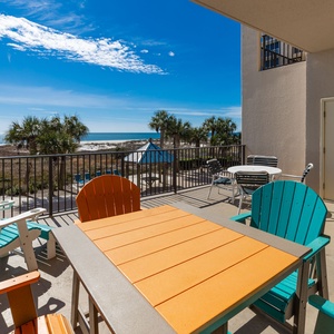 Relax on this spacious and colorful balcony, enjoying views of the beach and the coastal vibe around you