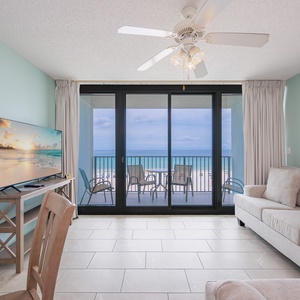 Relax in this inviting living area with a TV, sofa with queen sleeper and beachfront balcony views