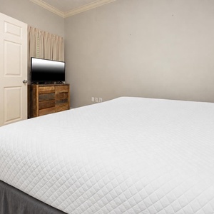 Relax on the cozy king bed in this guest suite and stream your favorite shows after a fun vacation day