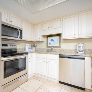 Kitchen featuring stainless appliances, granite countertops, and a cozy coffee maker for your morning brew