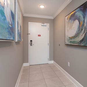 Step into a serene entryway, where coastal art sets the tone for your relaxing beach getaway experience