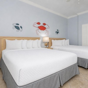 Two queen beds in the guest suite invite restful nights after lively days near the shore