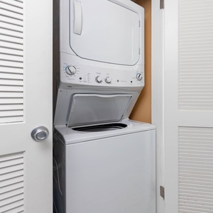 This laundry area features a stacked washer and dryer, providing convenience for guests during their stay