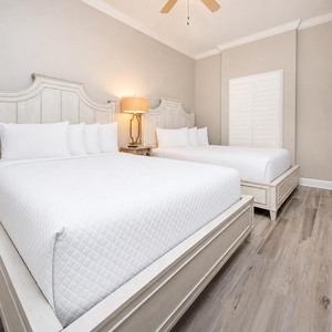 Unwind in soft, queen beds in this guest suite, welcoming restful nights and a serene vibe for your perfect coastal escape