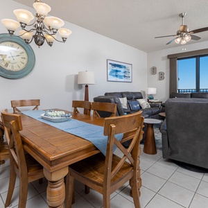 Gather around the wooden dining table, enjoying the inviting decor and comfortable seating in this welcoming space