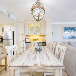 Rustic dining table invites laughter and stories as you gaze out toward the sparkling gulf coast beyond your balcony