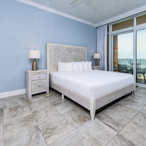 Retreat to the king master suite with cozy bedding and drift off to the sound of the waves from the balcony