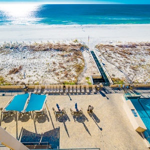 Relax by the poolside with lounge chairs, enjoying easy access to the beach and beautiful water views