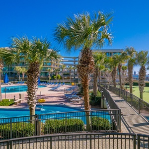 Bask in the sun by the sparkling pool and lazy river, surrounded by swaying palms and soothing coastal vibe