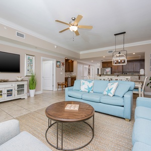 Unwind in the airy living area, where balcony breezes flow and you can stream your favorite shows