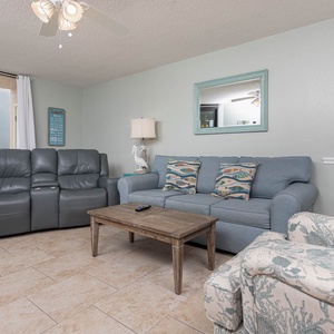 Unwind in the comfortable living area, featuring a sofa with queen sleeper and a charming coffee table