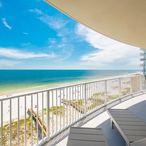 Relax on the spacious balcony enjoying the expansive views of the tranquil waters and beach below
