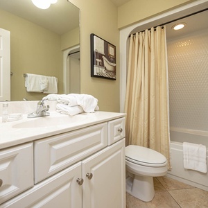 Indulge in a relaxing shower in this guest bath, making morning routines effortless with ample space for everyone