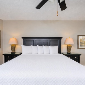 Gentle lamp glow highlights the king bed in the master suite, inviting restful nights and peaceful mornings