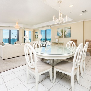 Dine at the glass table while enjoying beach views through large windows that fill the space with natural light