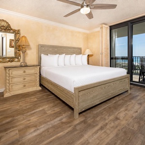 The master suite features a king bed, elegant furnishings, and access to a balcony with a view of the gulf