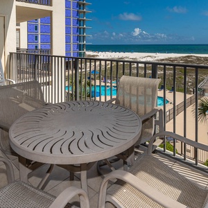 The balcony is a relaxing spot to enjoy views of the beach and pool area, perfect for unwinding after a day of fun