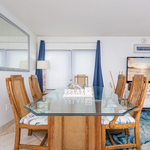 Gather around the glass table to share laughter and stories while enjoying the coastal vibe from your spacious living area