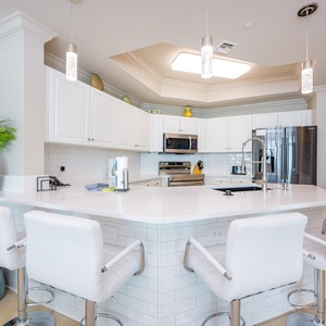 Wake up with morning coffee at the breakfast bar and get ready for a beach day in this stylish space