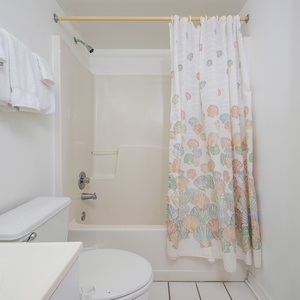 The master bathroom features a clean, bright design with a large mirror and ample counter space for your essentials
