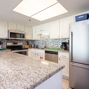 This kitchen features stainless appliances, granite countertops, a Keurig and coffee maker for your convenience