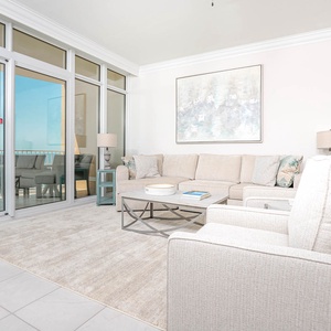 Relax on the cozy sofa with a queen sleeper in this inviting family room with breathtaking beachfront views