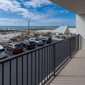 Enjoy a relaxing view from the balcony overlooking the beach, with comfortable seating and a peaceful atmosphere