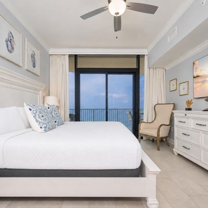 Serene master suite with a king bed, decorative pillows, and a beachfront view from your balcony