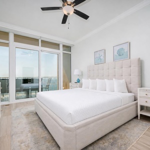 Retreat to this elegant king master suite with cozy bedding and drift off to the sound of the waves from the balcony
