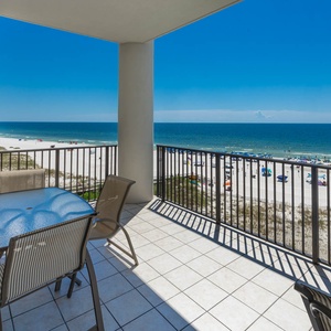 Enjoy stunning views from the balcony, featuring a glass-top table and chairs, perfect for relaxing in the sun