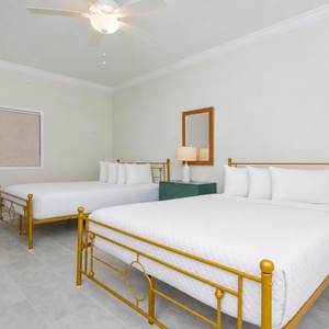 Relax in this bright guest room featuring two queen beds and stylish decor