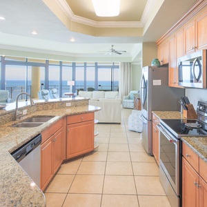 Prepare meals in this kitchen with elegant cabinetry, stainless appliances, and open design