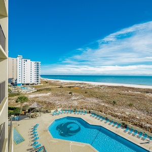 Relax on your balcony and bask in the sun while absorbing serene views of the inviting pool and coast