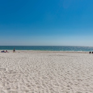 Relax on the soft, white sand with a stunning beachfront view and gentle waves just steps away from Seawind