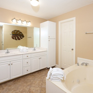 Refresh in the master bath after a day at the beach with a soothing jetted tub and relaxing walk-in shower