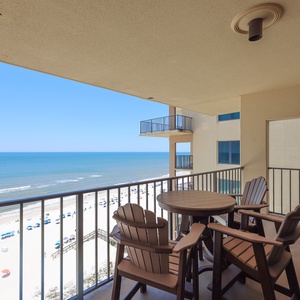 Relax on the private balcony with inviting seating and breathtaking views of the serene beach and sparkling waters