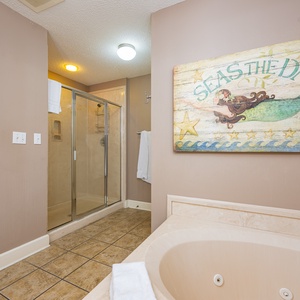Refresh in the master bath after a day at the beach with a soothing jetted tub and relaxing walk-in shower