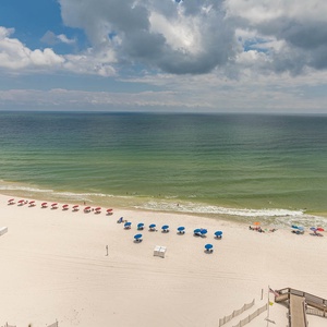 Enjoy the beach with colorful umbrellas lining the beach, inviting you to relax and soak up the sun