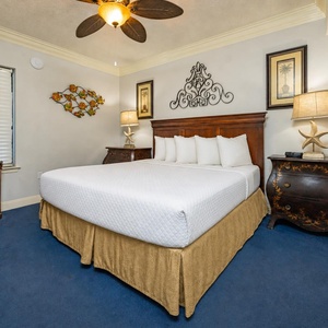 Drift off in the king suite surrounded by warm lamps and coastal-inspired art for a restful night