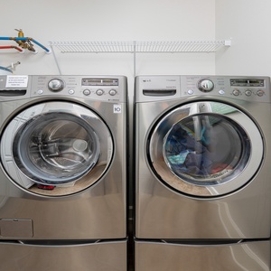 Conveniently wash and dry your clothes in the sleek laundry area, equipped with modern appliances for your comfort