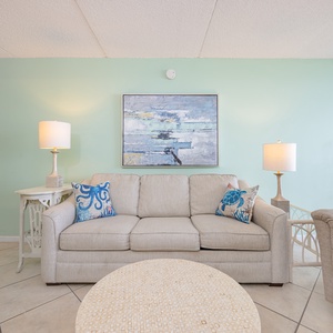 Sink into the plush couch as you enjoy quality time with loved ones, surrounded by a bright coastal vibe